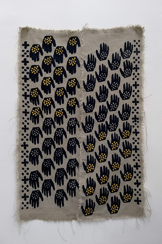 a pattern of black hands screen printed on tan fabric