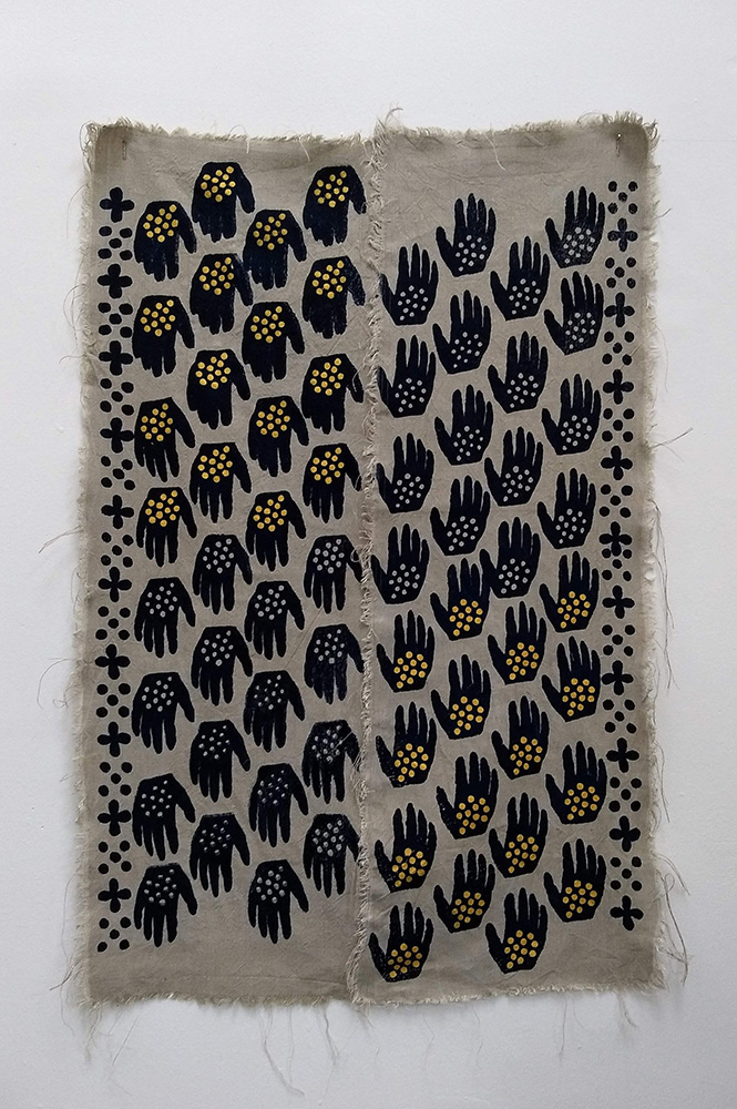 a pattern of black hands screen printed on tan fabric