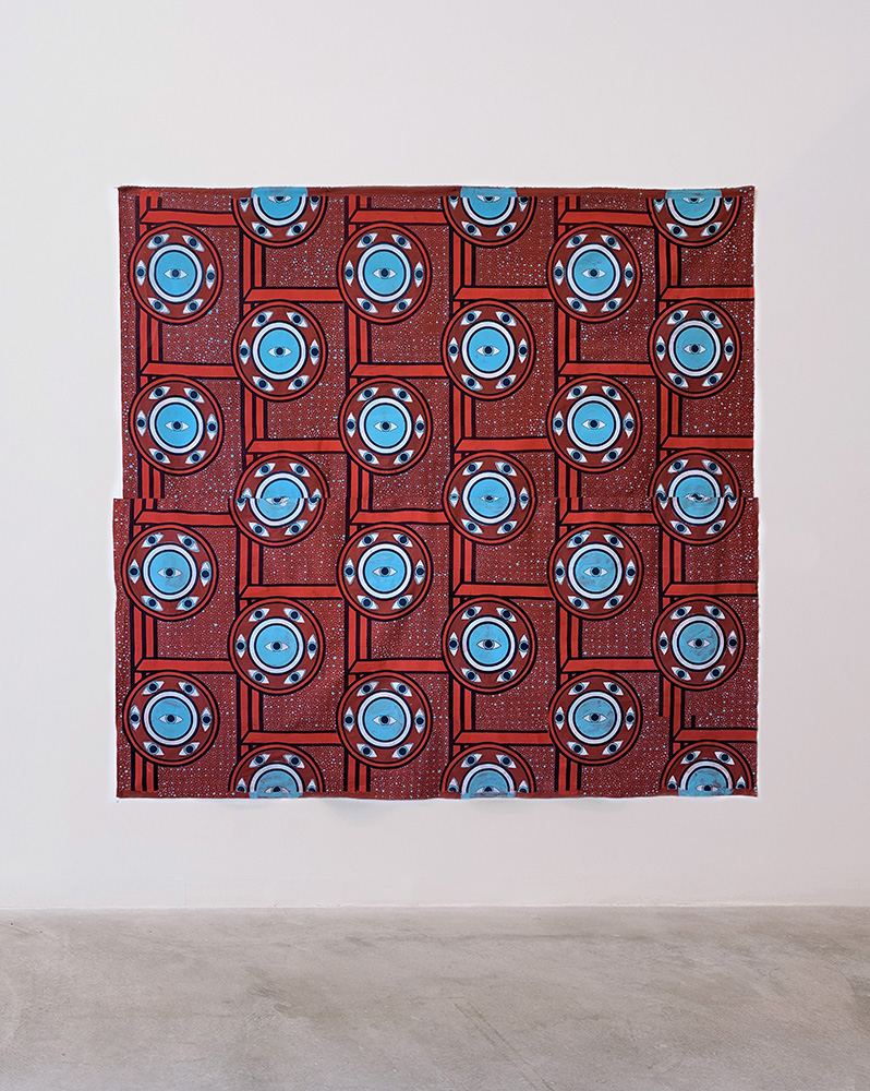 a red and blue pattern printed on a large piece of fabric