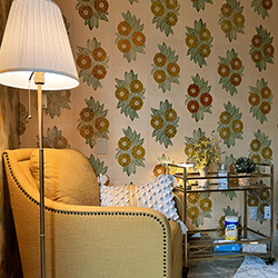 Photo of the Scott Family Infant Care Room with a large, comfy yellow chair, warm lighting, and amenities for caretakers and children