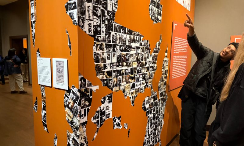 Artist Quaishawn Whitlock talks with visitors about his art at The Frick Pittsburgh.