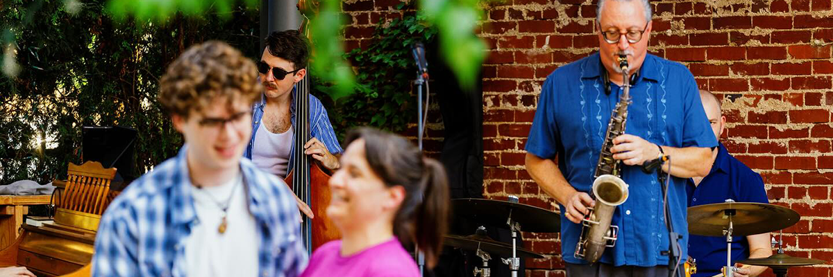 two people dance while a jazz band plays in the background