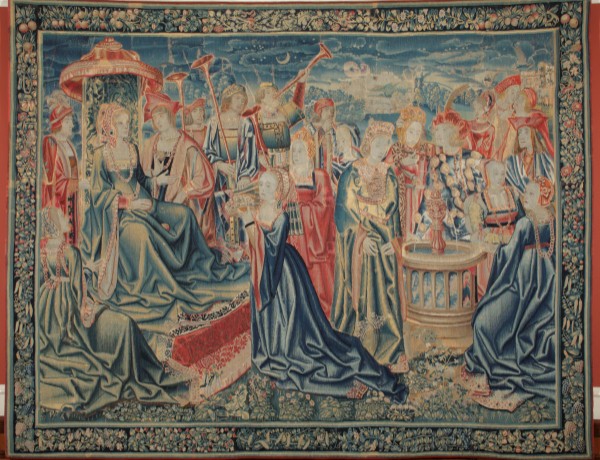 a man and woman gaze upon one another surrounded by their court