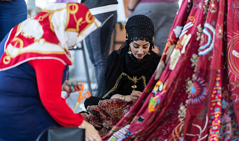 Sharmin Faeq Sadiq works on The Red Dress at the National Waterfront Museum in Swansea. Photo by Mark Pickthall.