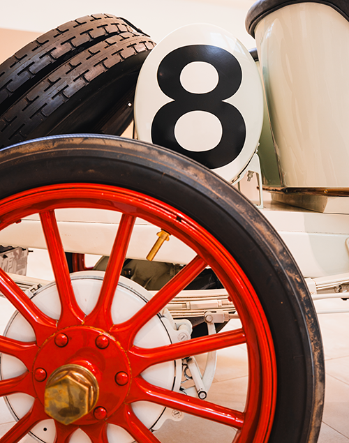 vintage cars on display in a museum