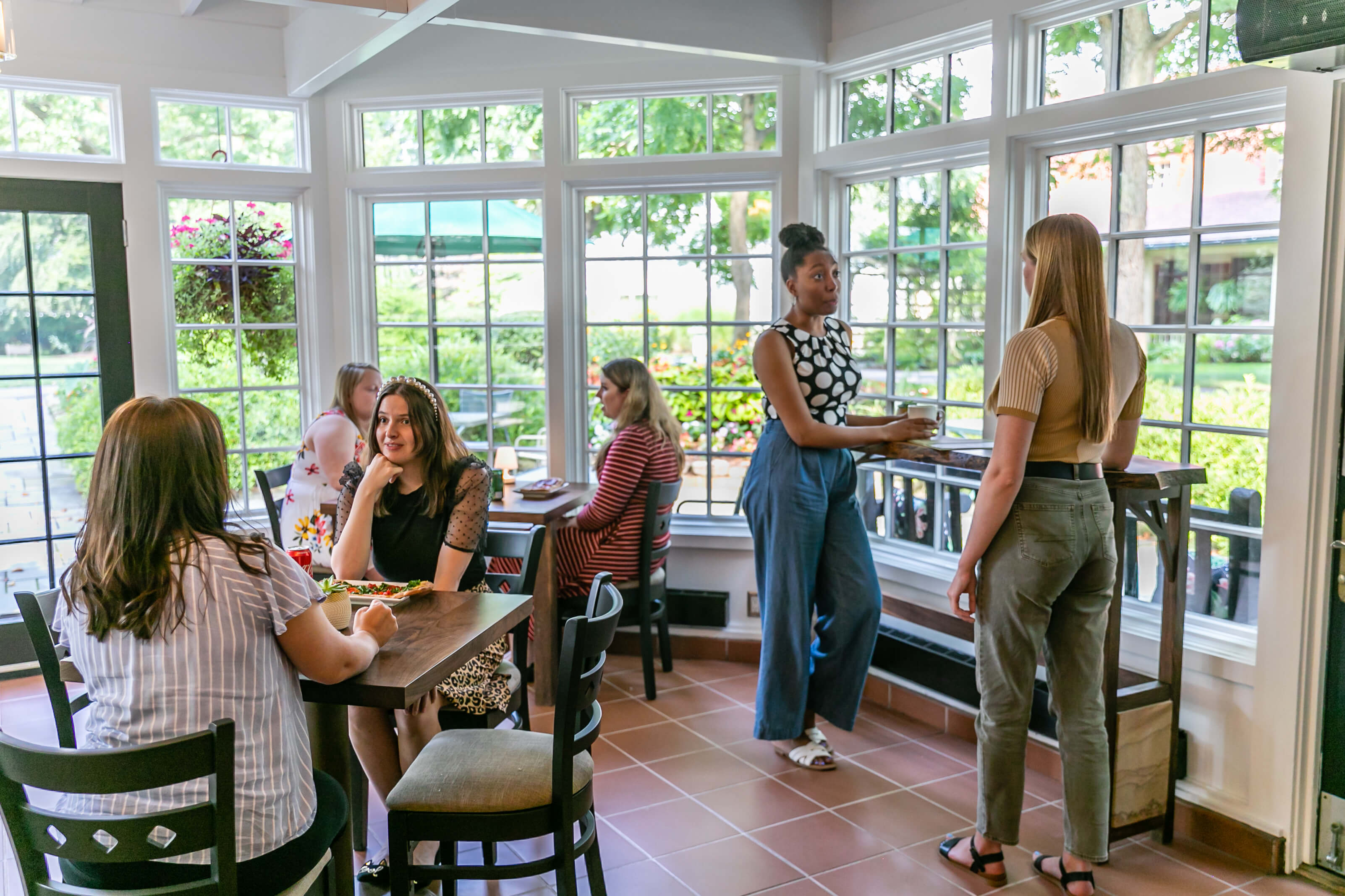 A group of people dining in the picturesque Cafe and The Frick in Pittsburgh, PA.