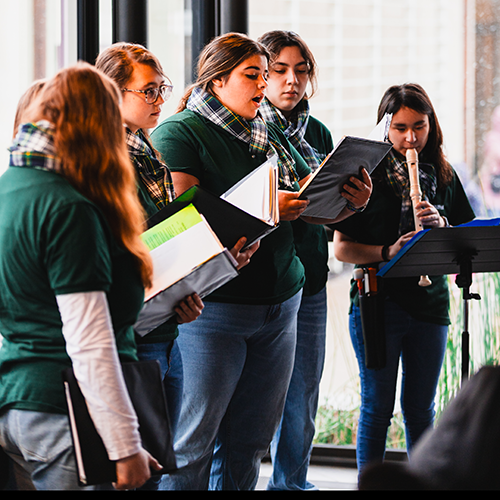 a group of teenagers singing in a choir