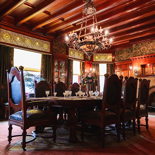 an ornately decorated dining room in a historic mansion