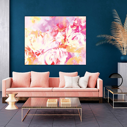 an abstract pink and orange painting hangs above a pink couch in a modern looking room