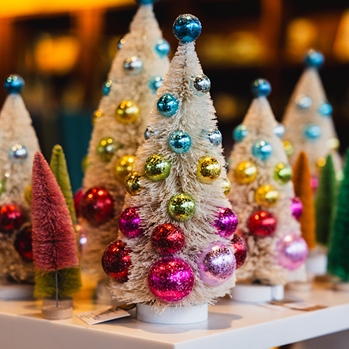 a collection of decorative christmas trees on display in a store