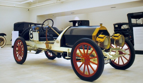 An open-air early automobile