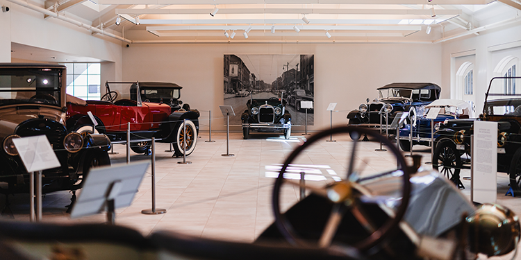 a selection of vintage automobiles on display in a museum