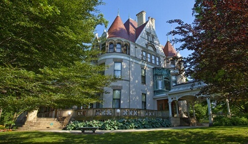 A victorian mansion with a  porte cochere