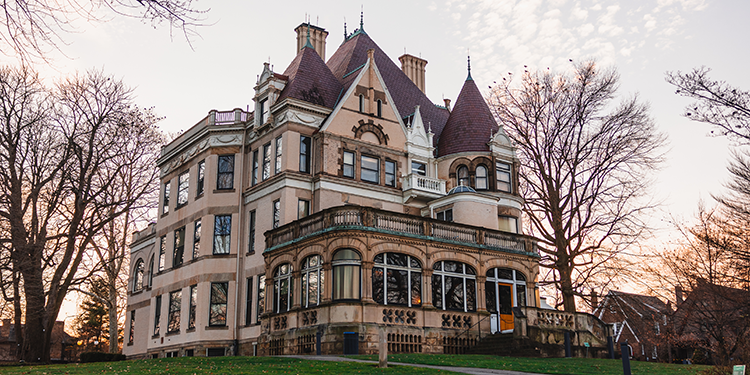 a historic mansion at sunset