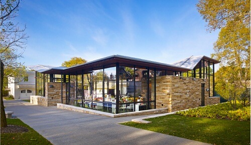 A large glass building with tan stone accents