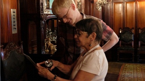 a tour guide shows a visitor a detail in Clayton